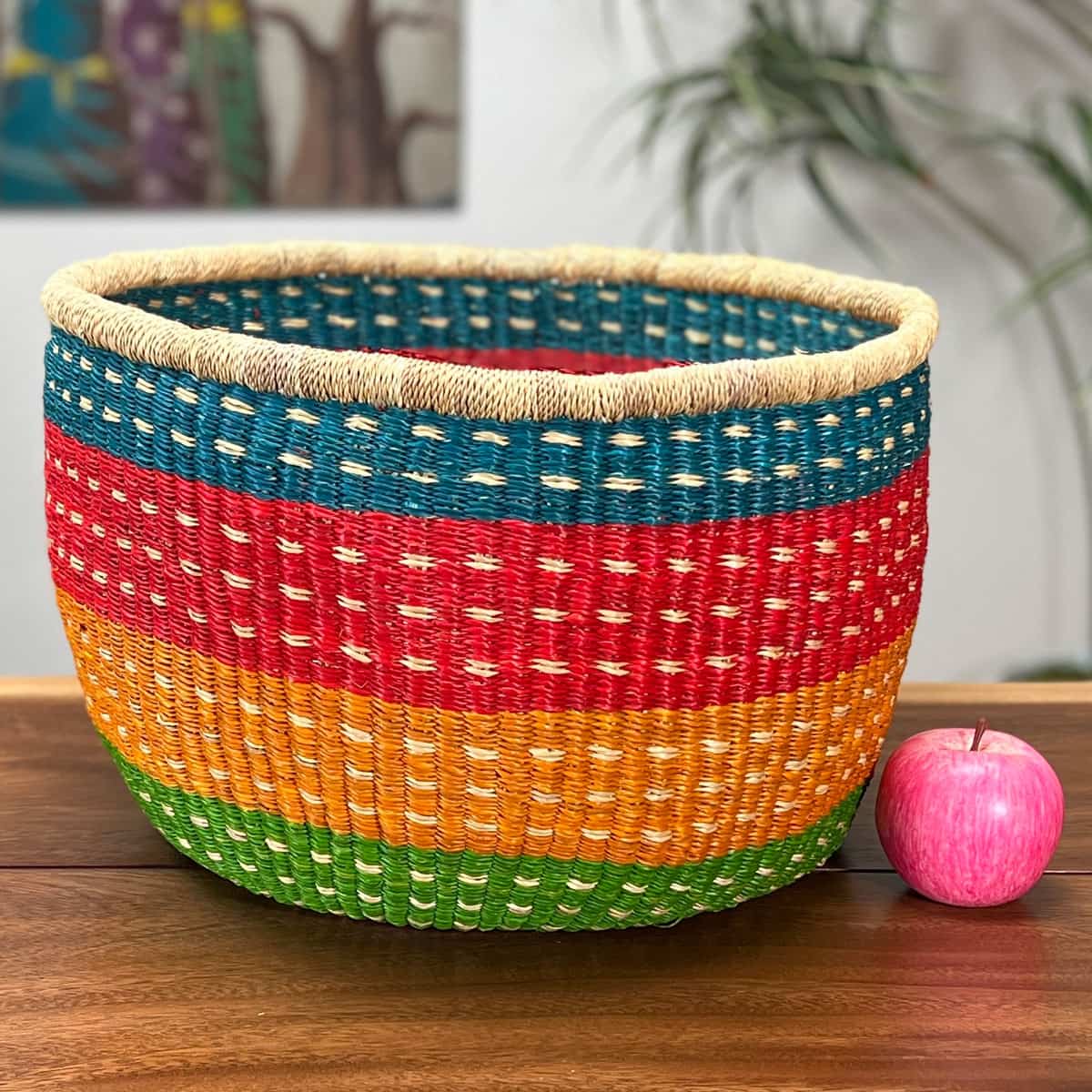 Colorful Round Basket without a handle next to an apple