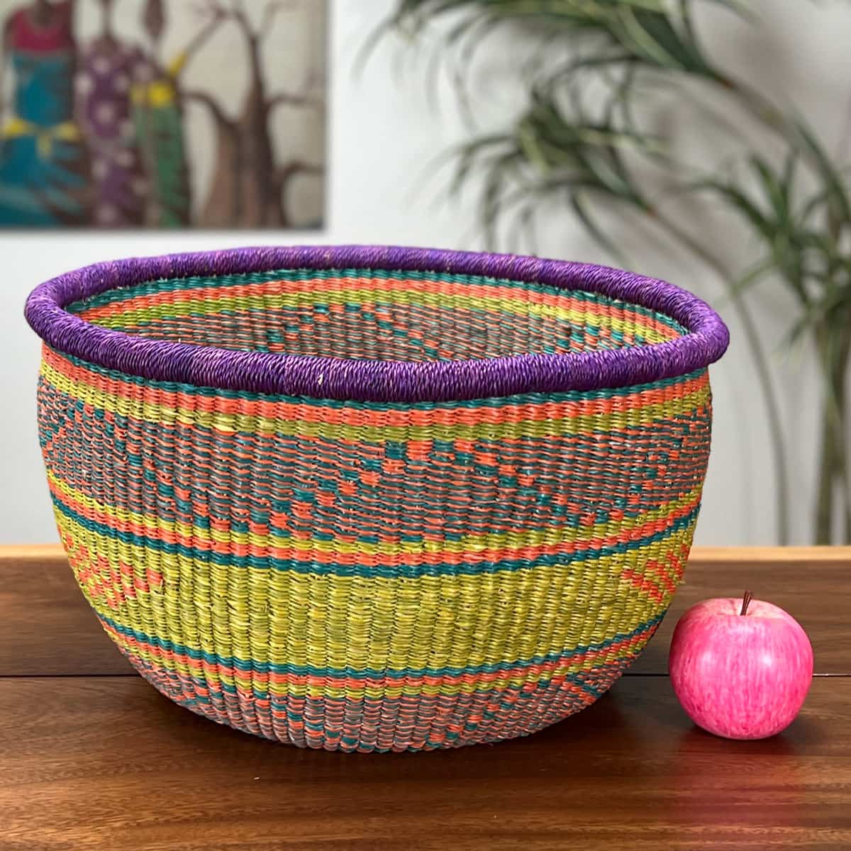 Colorful Round Basket without a handle next to an apple