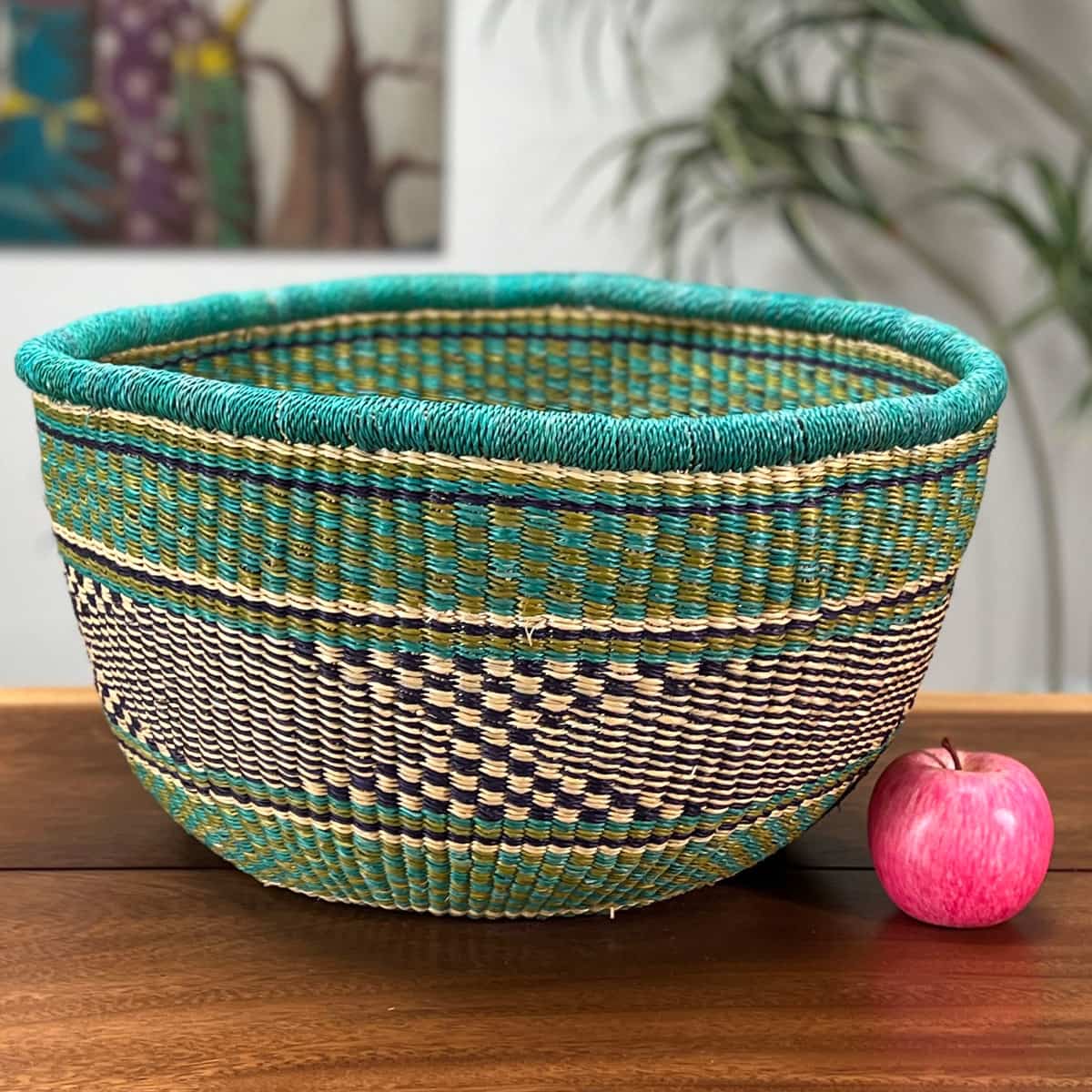 Colorful Round Basket without a handle next to an apple