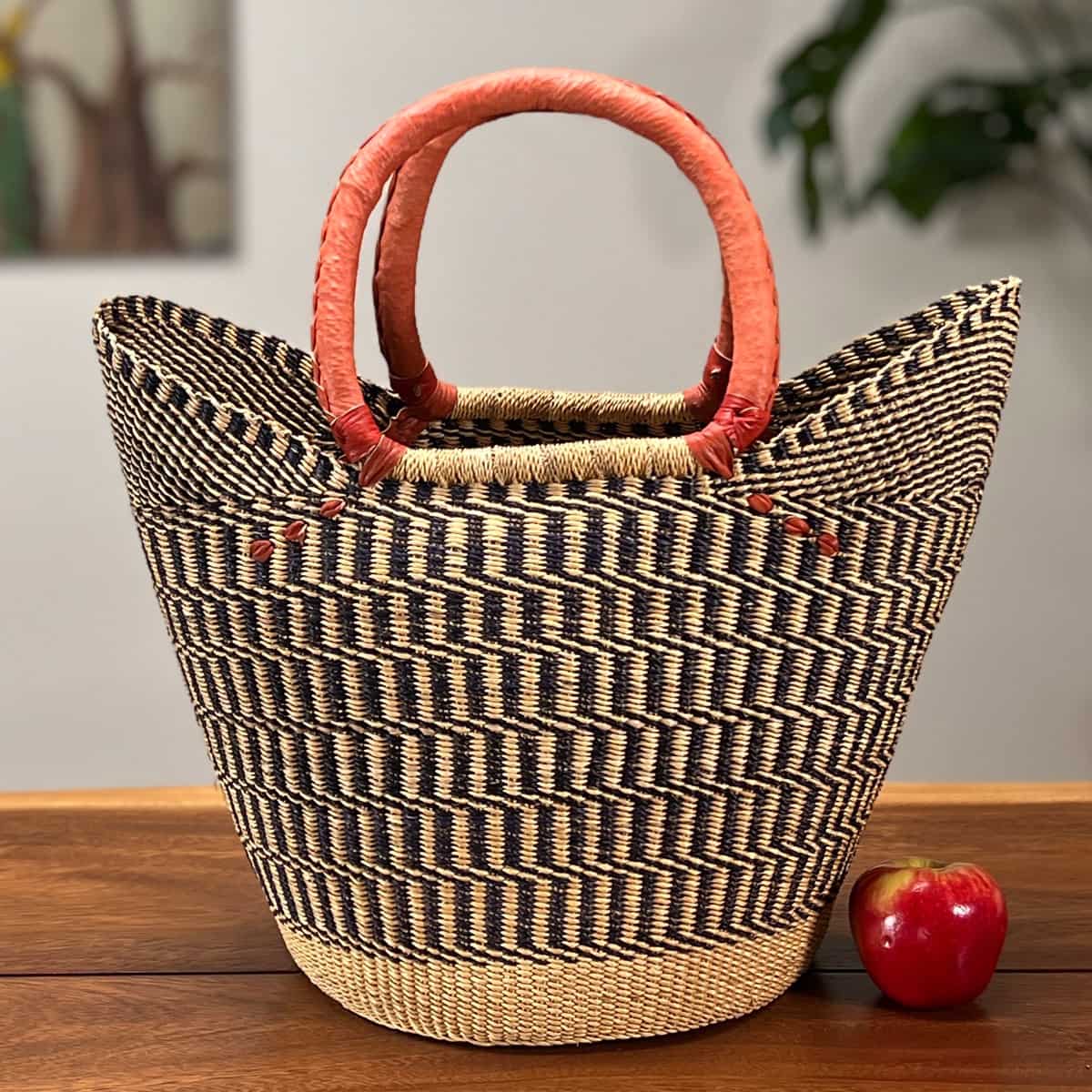 Shopping Tote Bolga Basket next to an apple